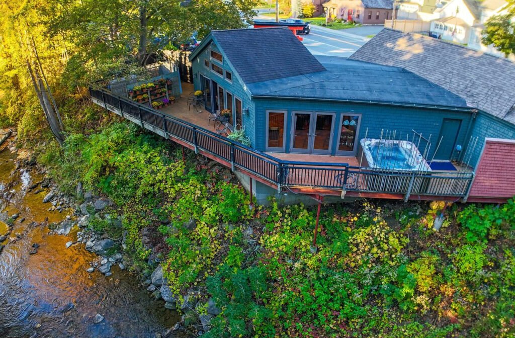 InTouch riverside building and deck above the Green River, with an outdoor hot tub